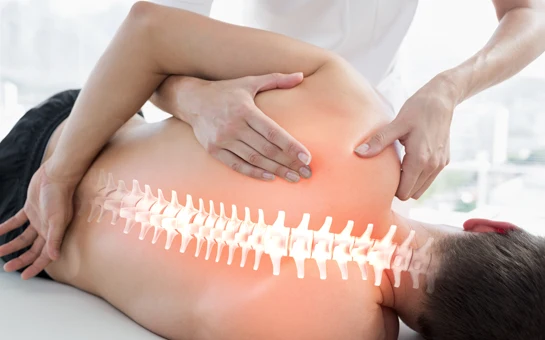 A chiropractor giving a patient a back exam.